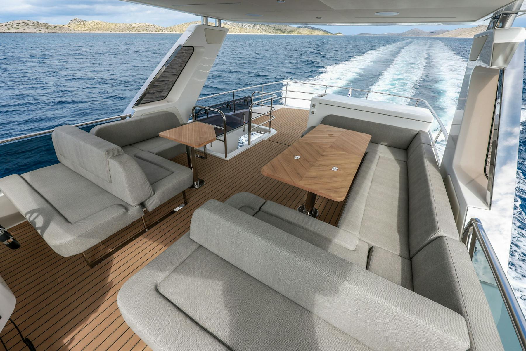 Greenline 58 Fly flybridge dining table and seating overlooking the water