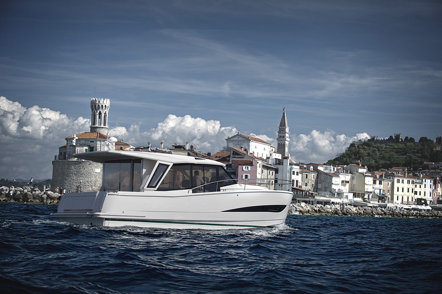 Greenline 39 seen from the stern quarter off a coastal town
