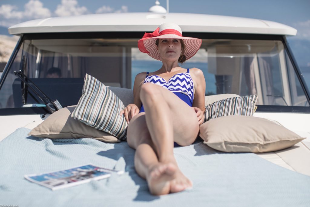 Woman reclining on the Greenline 39 bow sunpad